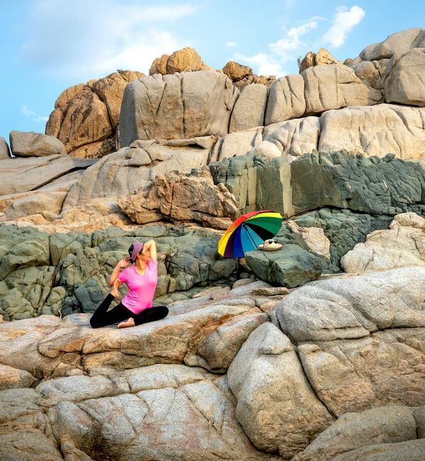 Person meditating in a serene natural environment, conveying peace and focus.